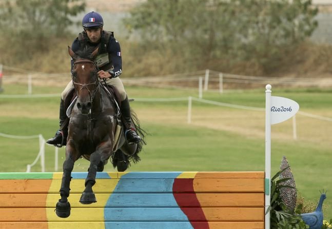 2016 Rio Olympics - Equestrian - Preliminary - Eventing Individual Cross Country -  Deodoro Olympic Equestrian Centre - Rio de Janeiro, Brazil - 08/08/2016. Astier Nicolas (FRA) of France riding Piaf De B'neville jumps the last obstacle.