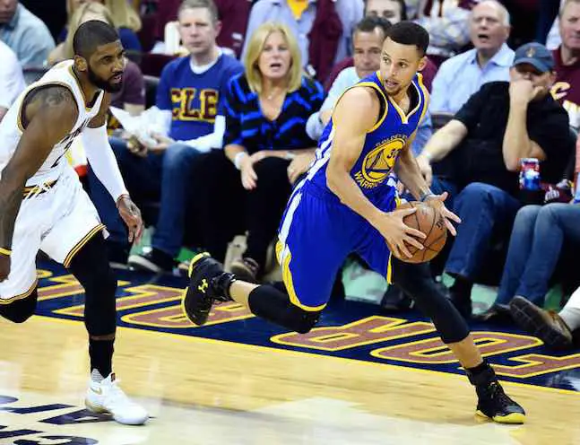 Golden State Warriors guard Stephen Curry (30) brings the ball up court against Cleveland Cavaliers guard Kyrie Irving (2) during the third quarter in game three of the NBA Finals at Quicken Loans Arena.
