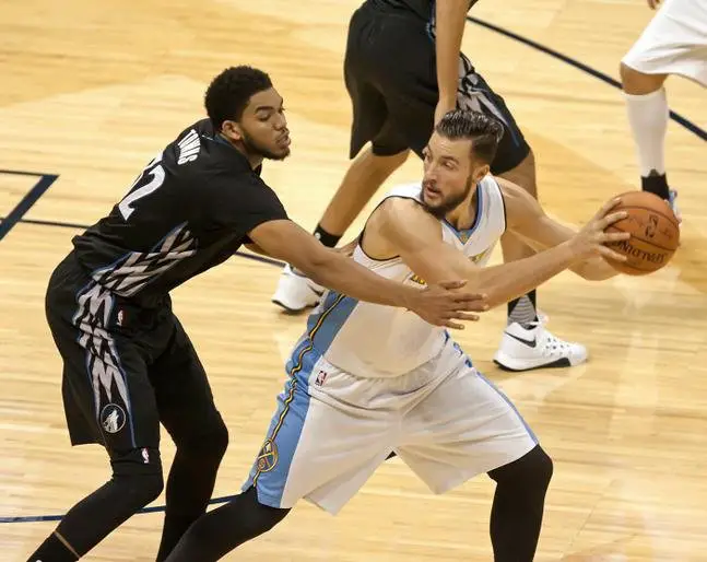 Oct. 30, 2015 - Denver, Colorado, U.S - Nuggets JOFFREY LAUVERGNE, right, shields the ball from Timberwolves KARL-ANTHONY TOWNS