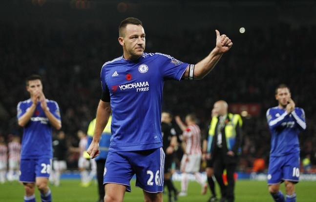 Chelsea's John Terry gestures to their fans as he walks off dejected at full time