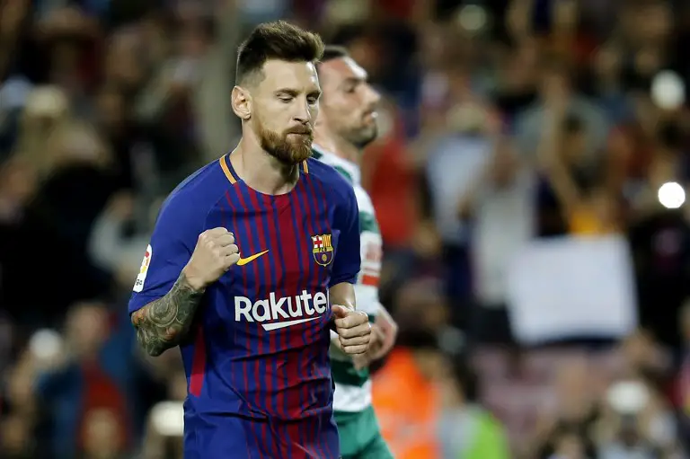 Barcelona's forward from Argentina Lionel Messi celebrates after scoring  during the Spanish league football match FC Barcelona against SD Eibar at the Camp Nou stadium in Barcelona on September 19, 2017. / AFP PHOTO / PAU BARRENA