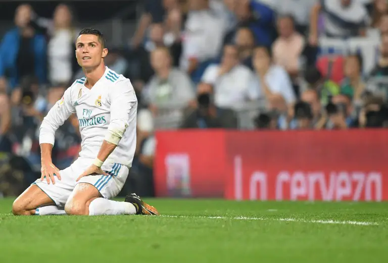 Real Madrid's forward from Portugal Cristiano Ronaldo kneels on the field during the Spanish league football match Real Madrid CF against Real Betis  at the Santiago Bernabeu stadium in Madrid on September 20, 2017. / AFP PHOTO / GABRIEL BOUYS