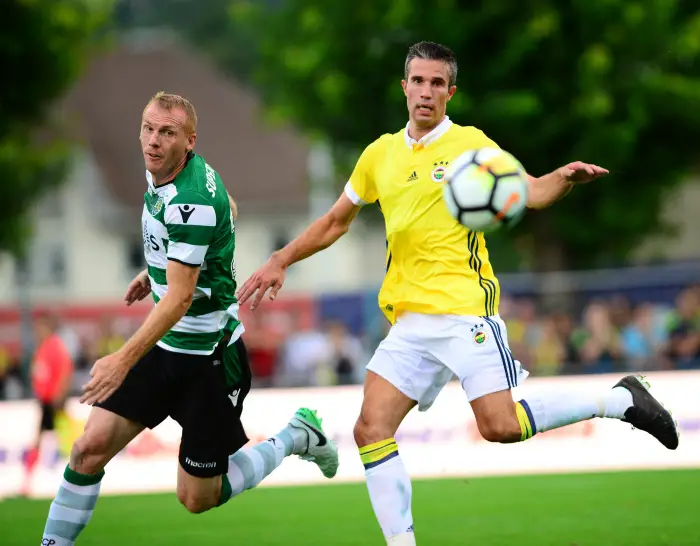 Robin van Persie (R) of Fenerbahce and Jeremy Mathieu (L) of Sporting Lisbon during the Friendly match between Fenerbahce and Sporting Lisbon at Stade du Sensuy in Renens , Swiss on July 12 , 2017.