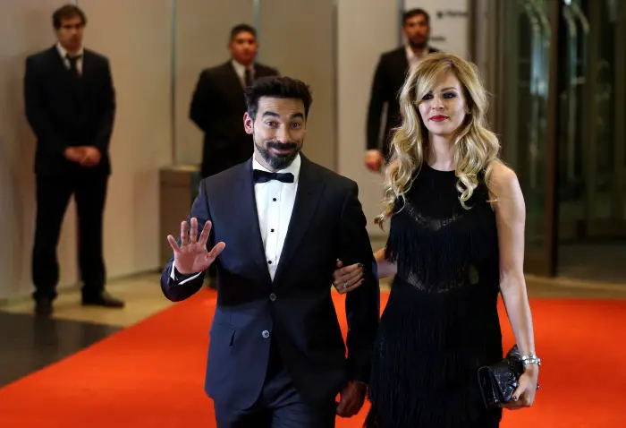 Argentine soccer player Ezequiel Lavezzi and Yanina Screpante pose for photographers as they arrive to the wedding of Lionel Messi and Antonela Roccuzzo in Rosario, Argentina, June 30, 2017.