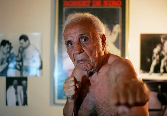 Former middleweight boxing champion Jake LaMotta poses in New York October 28, 2009. LaMotta learned to fight with an ice pick in his hand in a Bronx schoolyard, battering all the way in later life to a world middleweight title in an era of 15-round fights.