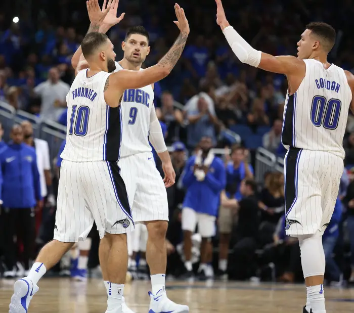The Orlando Magic's Evan Fournier (10), Nikola Vucevic (9), and Aaron Gordon (00) celebrate amid a 116-109 win against the Miami Heat at the Amway Center in Orlando, Fla., on Wednesday, Oct. 18, 2017.