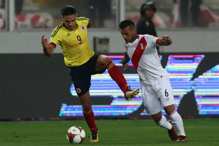 Soccer Football - 2018 World Cup Qualifiers - Peru v Colombia - Nacional Stadium, Lima, Peru - October 10, 2017. Peru's Miguel Trauco and Colombia's Rodamel Falcao