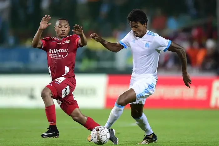 Luis Gustavo midfielder of OM is fighting for the ball with Andile Ernest Jali midfielder of KV Ostende