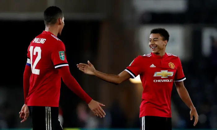Manchester United's Jesse Lingard celebrates after the match with Chris Smalling