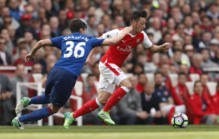 Arsenal's Mesut Ozil in action with Manchester United's Matteo Darmian