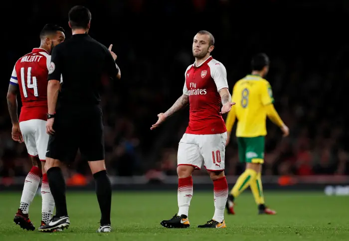 Referee Andy Madley speaks with Arsenal's Jack Wilshere