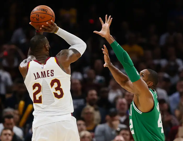 October 17, 2017 - Cleveland, OH, USA - With a ripped jersey, the Cleveland Cavaliers' LeBron James (23) puts up a shot over the Boston Celtics' Al Horford in the fourth quarter on Tuesday, Oct. 17, 2017, at Quicken Loans Arena in Cleveland. The Cavs won, 102-99.