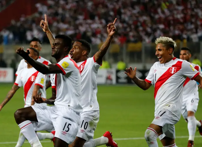Peru's Christian Ramos (15) celebrates near teammates after scoring.