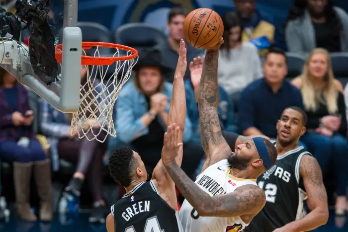 New Orleans Pelicans center DeMarcus Cousins (0) drives to the basket against San Antonio Spurs guard Danny Green (14) at the Smoothie King Center in New Orleans.