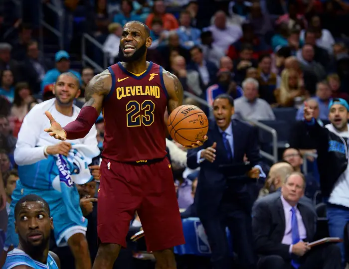 November 15, 2017 - Charlotte, NC, USA - The Cleveland Cavaliers' Lebron James reacts to being called for a foul as the Charlotte Hornets' Michael Kidd-Gilchrist, bottom left, looks back at the call in the second half on Wednesday, Nov. 15, 2017, at the Spectrum Center in Charlotte, N.C. The Cavaliers won, 115-107.