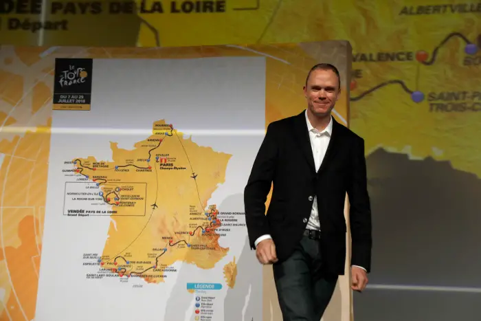 Tour de France 2017 winner Chris Froome of Britain poses with map of the itinerary of the 2018 Tour de France cycling race during a news conference in Paris, France, October 17, 2017