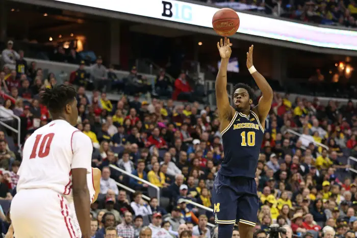 Michigan Wolverines guard Derrick Walton Jr. (10) shoots the ball over Wisconsin Badgers forward Nigel Hayes (10)