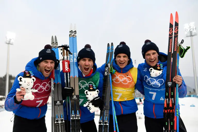 (From L) Bronze medallist team France Jean Marc Gaillard, Maurice Manificat, Clement Parisse and Adrien Backscheider celebrates during the victory ceremony on the podium during the men's 4x10kms classic freestyle cross country relay at the Alpensia cross country ski centre during the Pyeongchang 2018 Winter Olympic Games on February 18, 2018 in Pyeongchang.  / AFP PHOTO / Jonathan NACKSTRAND