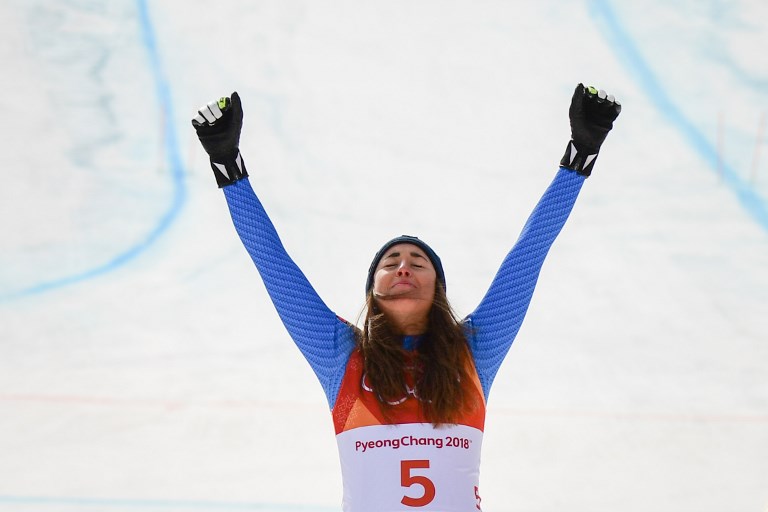 Italy's Sofia Goggia celebrates during the victory ceremony of the women's Downhill at the Jeongseon Alpine Center during the Pyeongchang 2018 Winter Olympic Games on February 21, 2018 in Pyeongchang. / AFP PHOTO / Martin BERNETTI
