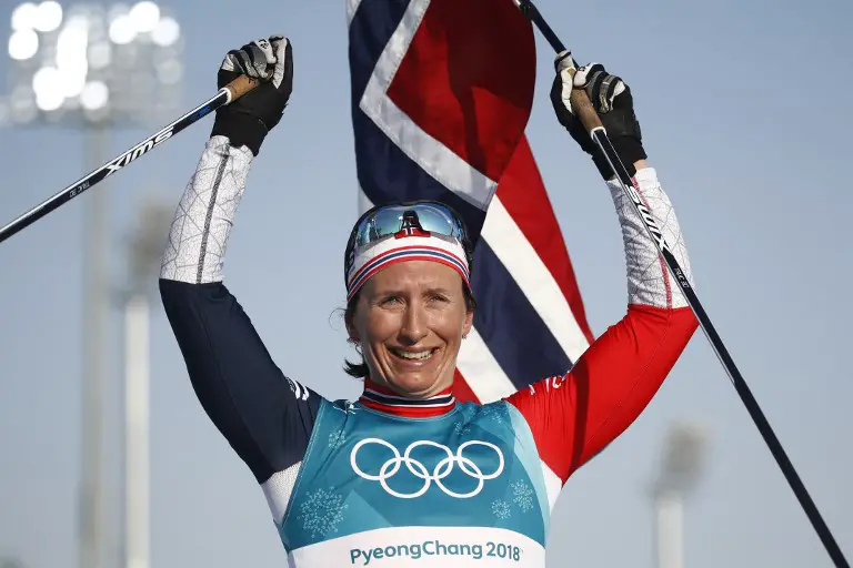 Norway's Marit Bjoergen celebrates her gold medal win in the women's 30km cross country mass start classic at the Alpensia cross country ski centre during the Pyeongchang 2018 Winter Olympic Games on February 25, 2018 in Pyeongchang.  / AFP PHOTO / Odd ANDERSEN