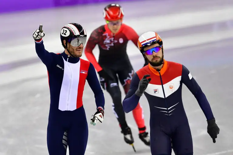 France's Thibaut Fauconnet (L) reacts beside Netherlands' Sjinkie Knegt in the men's 1,500m short track speed skating semi-final event during the Pyeongchang 2018 Winter Olympic Games, at the Gangneung Ice Arena in Gangneung on February 10, 2018. / AFP PHOTO / Mladen ANTONOV