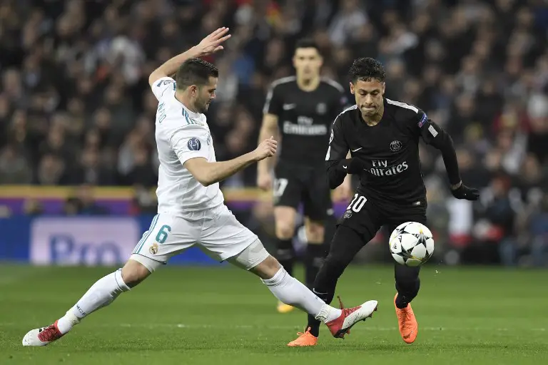 Real Madrid's Spanish defender Nacho Fernandez (L) vies with Paris Saint-Germain's Brazilian forward Neymar (R) during the UEFA Champions League round of sixteen first leg football match Real Madrid CF against Paris Saint-Germain (PSG) at the Santiago Bernabeu stadium in Madrid on February 14, 2018.   / AFP PHOTO / GABRIEL BOUYS