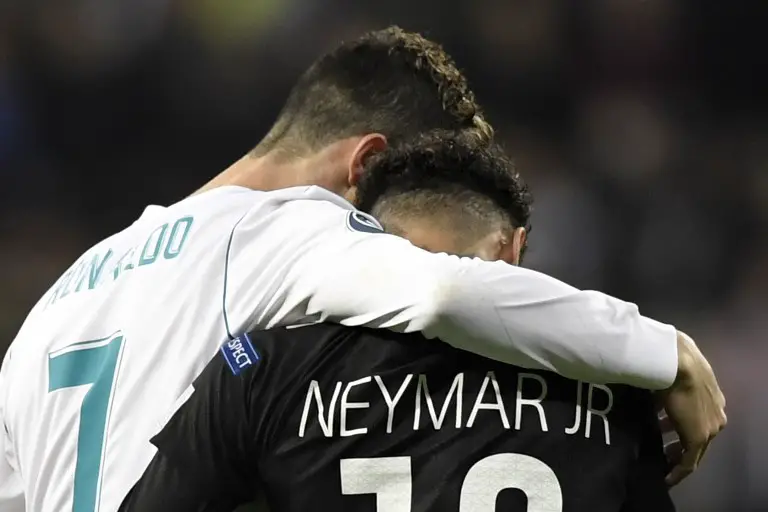 Real Madrid's Portuguese forward Cristiano Ronaldo (L) and Paris Saint-Germain's Brazilian forward Neymar leave the pitch during the UEFA Champions League round of sixteen first leg football match Real Madrid CF against Paris Saint-Germain (PSG) at the Santiago Bernabeu stadium in Madrid on February 14, 2018.   / AFP PHOTO / GABRIEL BOUYS