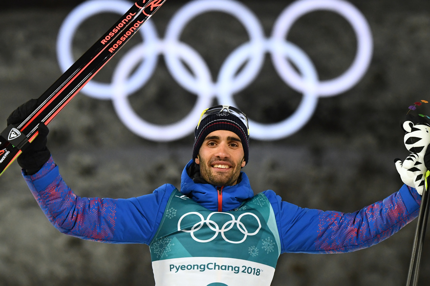 France's winner Martin Fourcade celebrates on the podium during the victory ceremony after competing in the men's 12,5km pursuit biathlon event during the Pyeongchang 2018 Winter Olympic Games in Pyeongchang on February 12, 2018. / AFP PHOTO / FRANCK FIFE