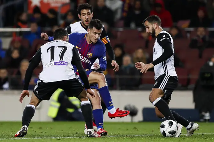 Philippe Coutinho of FC Barcelona takes on three defenders of Valencia CF
