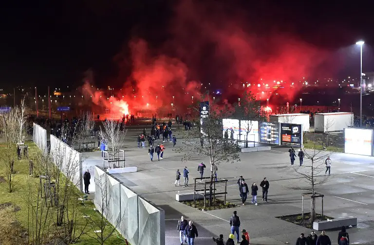 Lyon's fans use red flares before before the Europa League football match Olympique Lyonnais (OM) vs CSKA Moscow on March 15, 2018, at the Groupama Stadium in Decines-Charpieu, central-eastern France. / AFP PHOTO / ROMAIN LAFABREGUE