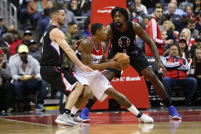 Dec 18, 2016; Washington, DC, USA; Washington Wizards guard Bradley Beal (middle) holds the ball as LA Clippers guard J.J. Redick (left) and Clippers center DeAndre Jordan (6) defend in the first quarter at Verizon Center.