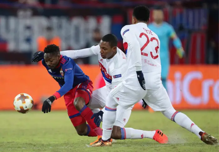 MOSCOW, RUSSIA nÃÉ MARCH 8, 2018: CSKA Moscow's Ahmed Musa and Lyon's Marcelo, Kenny Tete (L-R) fight for the ball in the first leg of their 2017/18 UEFA Europa League Round of 16 football match at VEB Arena Stadium.