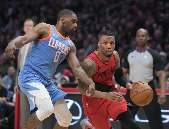 Damian Lillard #0 of the Portland Trailblazers drives against Sindarius Thornwell #0 of the Los Angeles Clippers
