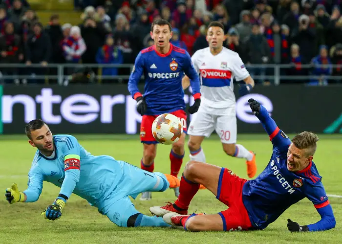 MOSCOW, RUSSIA nÃÉ MARCH 8, 2018: CSKA Moscow's Alan Dzagoev (C), Pontus Wernbloom (R) and Lyon's goalkeeper Anthony Lopes (L) fight for the ball in the first leg of their 2017/18 UEFA Europa League Round of 16 football match at VEB Arena Stadium.