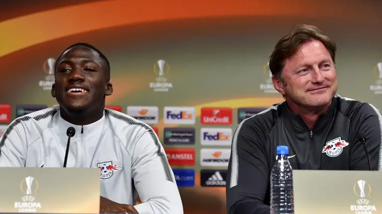 Leipzig's French defender Ibrahima Konate (L) and Leipzig's Austrian head coach Ralph Hasenhuettl give a press conference on the eve of the quarter final Europa League football match RB Leipzig vs Olympique de Marseille (OM) at the Red Bull arena in Leipzig, eastern Germany, on April 4, 2018. / AFP PHOTO / John MACDOUGALL