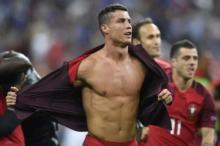 Portugal's forward Cristiano Ronaldo takes off his jacket after beating France 1-0 in the Euro 2016 final football match between France and Portugal at the Stade de France in Saint-Denis, north of Paris, on July 10, 2016. / AFP PHOTO / MARTIN BUREAU