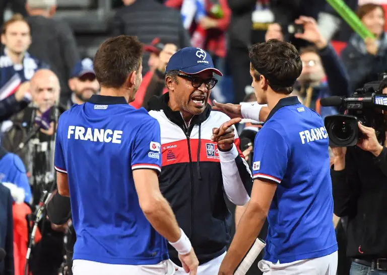 France's Pierre-Hugues Herbert and Nicolas Mahut celebrate with France's captain Yannick Noah (C) after winning their Davis Cup semi-final tennis match against Serbia at the Pierre Mauroy Stadium in Lille, northern France, on September 16, 2017.   / AFP PHOTO / DENIS CHARLET
