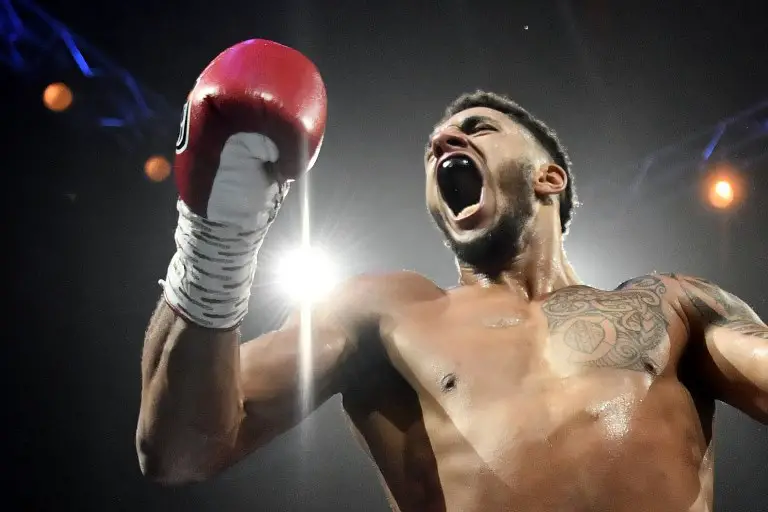 France's Tony Yoka celebrates after winning his Heavy weight boxing bout against Belgium's  Ali Baghouz, on December 16, 2017 in Boulogne-Billancourt. / AFP PHOTO / CHRISTOPHE SIMON