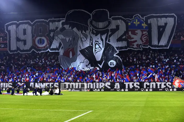 Lyon's fans hold a banner reading 1987-2017 as they celebrate the 30 years anniversary of the supporters club "Bad Gones" during the French L1 football match between Lyon (OL) and Marseille (OM) on December 17, 2017, at the Groupama stadium in Decines-Charpieu near Lyon, central-eastern France. / AFP PHOTO / ROMAIN LAFABREGUE