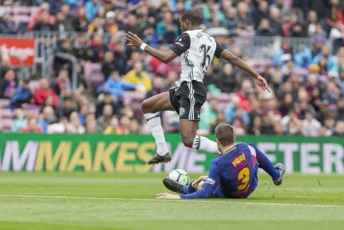 FC Barcelona defender Gerard Pique (3) and Valencia CF midfielder Geoffrey Kondogbia (16) during the match between FC Barcelona against Valencia CF, for the round 32 of the Liga Santander, played at Camp Nou Stadium on 14th April 2018 in Barcelona, Spain.