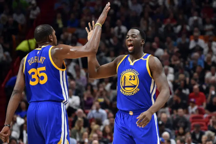 Jan 23, 2017; Miami, FL, USA; Golden State Warriors forward Draymond Green (right) celebrates with Warriors forward Kevin Durant (left) during the first half against the Miami Heat at American Airlines Arena.