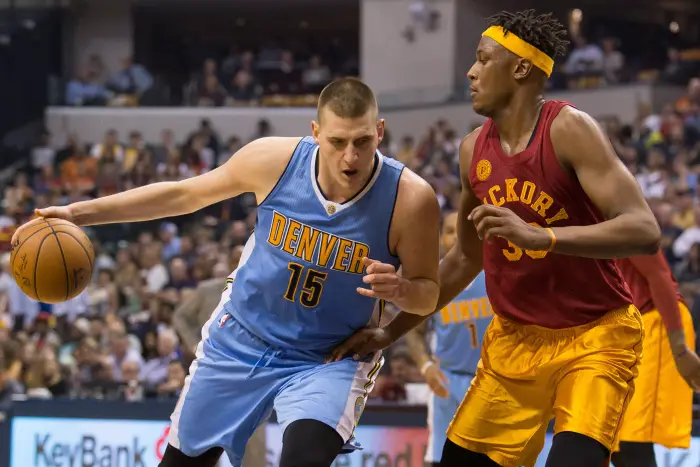 Denver Nuggets forward Nikola Jokic (15) dribbles the ball while Indiana Pacers center Myles Turner (33)