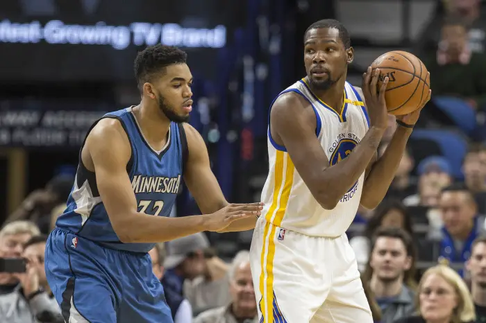 Golden State Warriors forward Kevin Durant (35) holds the ball as Minnesota Timberwolves center Karl-Anthony Towns (32)
