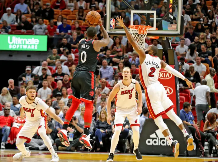 April 11, 2018 - Miami, FL, USA - The Toronto Raptors' C.J. Miles (0) launches a shot under pressure from the Miami Heat's Wayne Ellington (2) in the first quarter at the AmericanAirlines Arena in Miami on Wednesday, April 11, 2018.
