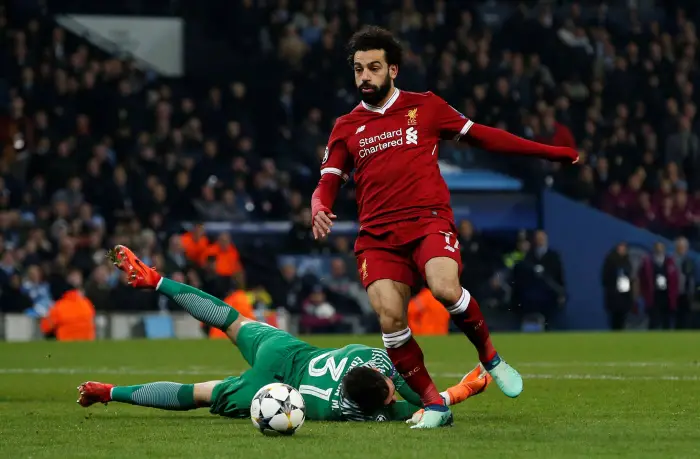 Liverpool's Mohamed Salah rounds Manchester City's Ederson to score their first goal
