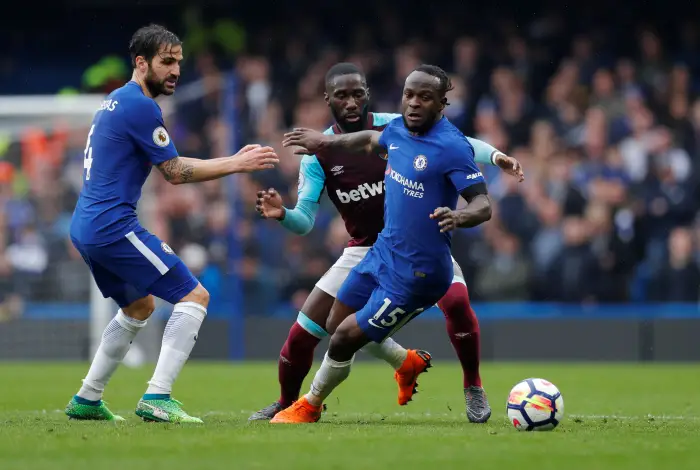 Chelsea's Victor Moses and Cesc Fabregas in action with West Ham United's Arthur Masuaku