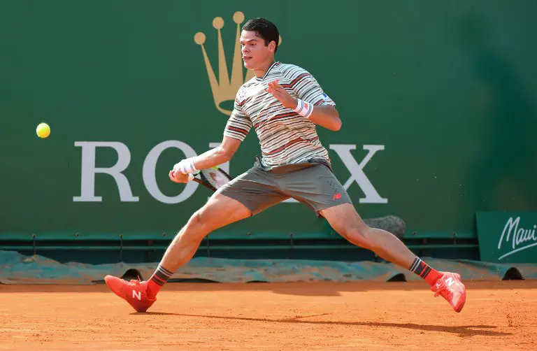 Canada's Milos Raonic hits a return to Italy's Marco Cecchinato during their men's single tennis match at the Monte-Carlo ATP Masters Series Tournament, on April 18, 2018 in Monaco.  / AFP PHOTO / YANN COATSALIOU