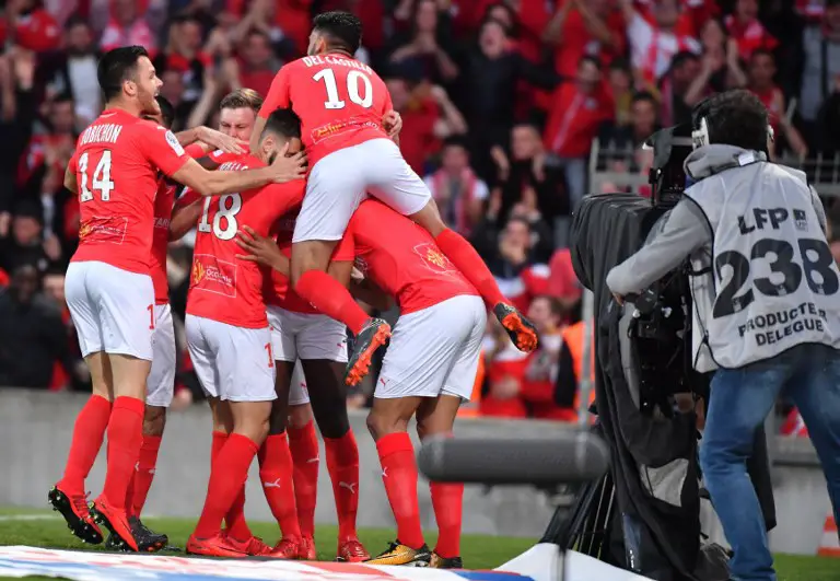 Nimes's players react after scoring a goal during the French L2 football match between Nimes and Ajaccio, on May 4, 2018 at the les Costieres Stadium in Nimes, southern France. / AFP PHOTO / PASCAL GUYOT