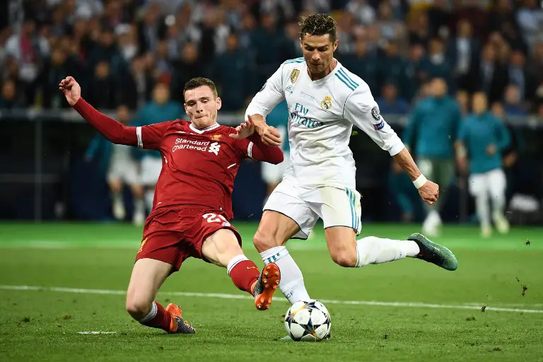 Liverpool's Scottish defender Andrew Robertson (L) vies for the ball with Real Madrid's Portuguese forward Cristiano Ronaldo (R) during the UEFA Champions League final football match between Liverpool and Real Madrid at the Olympic Stadium in Kiev, Ukraine, on May 26, 2018. / AFP PHOTO / FRANCK FIFE
