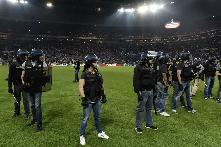 French police stand guard after clashes between supporters before the UEFA Europa League first leg quarter final football match between Lyon (OL) and Besiktas on April 13, 2017, at the Parc Olympique Lyonnais stadium in Decines-Charpieu, central-eastern France.  / AFP PHOTO / JEFF PACHOUD